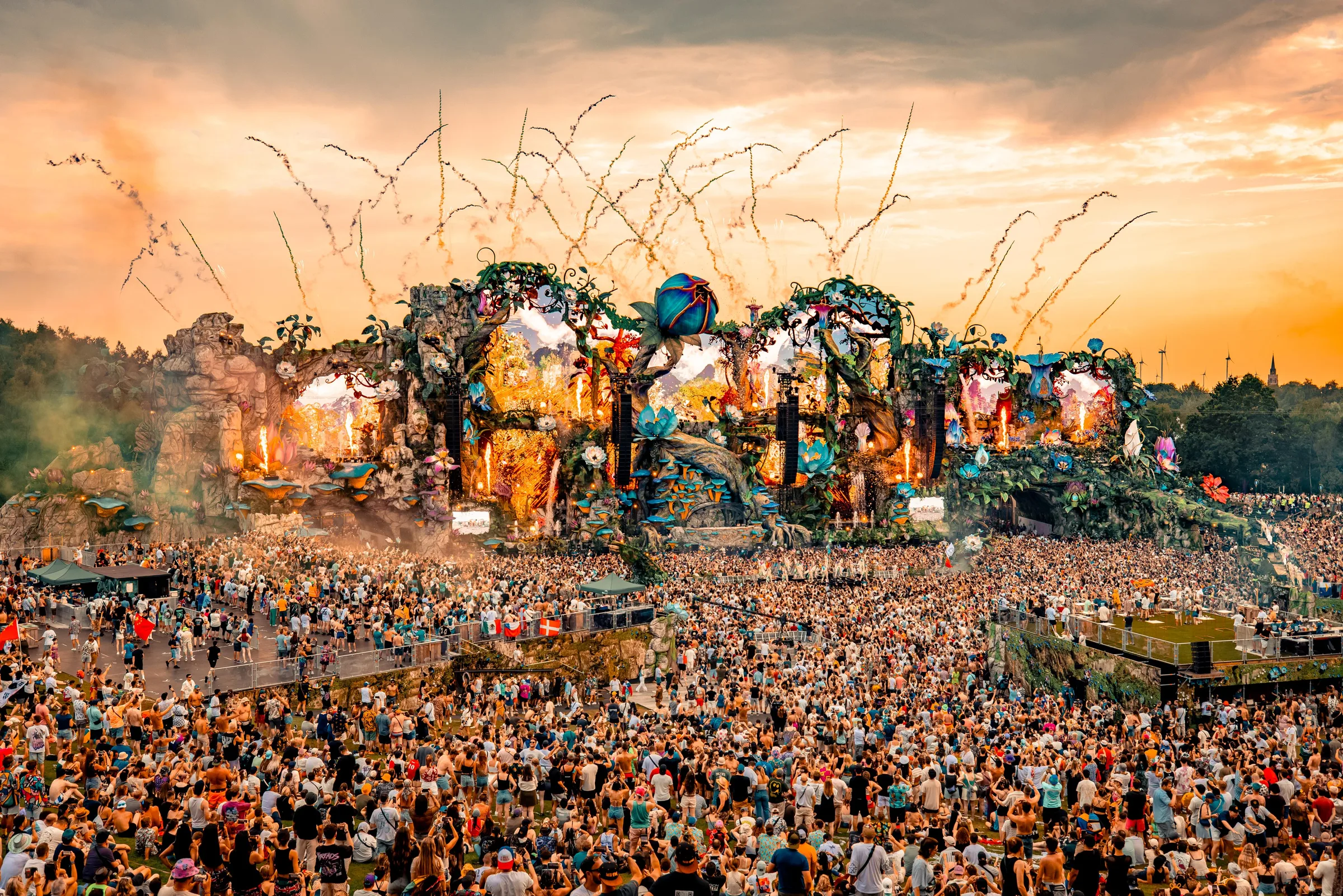 Tomorrowland mainstage at sunset with massive crowd